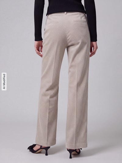 Frauenmodel trägt Regular Fit Cordhose mit angedeuteten Taschen Modell 'AMELIE' von CAMBIO in Beige, Damen Cordhose, Ganzkörperansicht Rückansicht, KI-modifiziertes Bild.