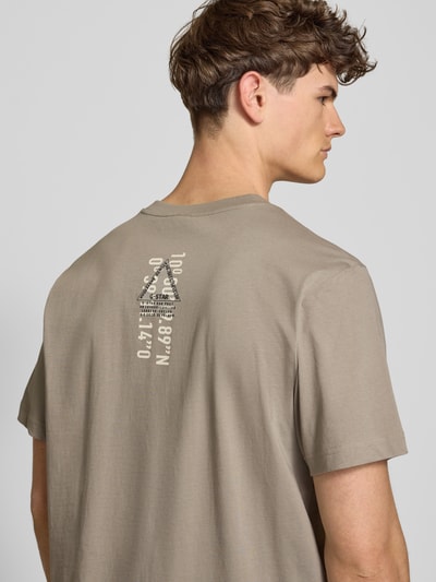 Männermodel trägt T-Shirt aus Baumwolle mit Rundhalsausschnitt von G-Star Raw in Beige, glatte Struktur, Regular Fit, Rückenansicht.