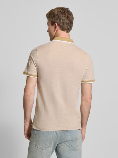 Männermodel trägt Slim Fit Poloshirt mit Viskose-Anteil Modell 'Paulos' von JACK & JONES, beige mit Polokragen, Baumwoll-Mix, Logo-Stitching, Ganzkörperansicht Rückansicht.