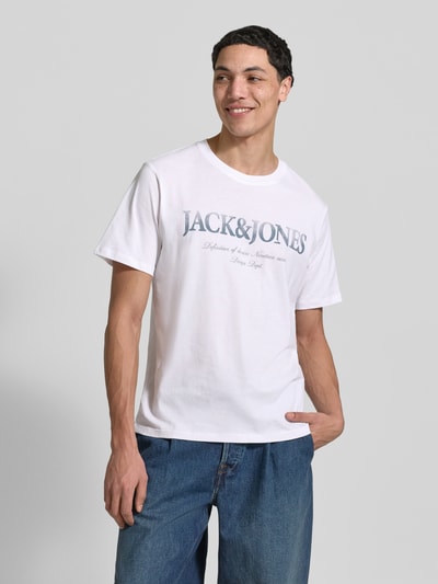Männermodel trägt weißes T-Shirt aus Baumwolle Modell 'DEVIN' von Jack & Jones mit Label-Print, gerader Schnitt, Nahaufnahme Oberkörper.