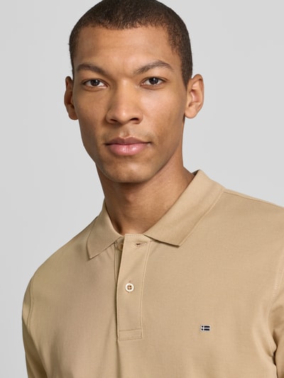 Männermodel trägt Regular Fit Poloshirt mit Stitching von Christian Berg Men in Beige, reine Baumwolle, Knopfleiste, Nahaufnahme Oberkörper.