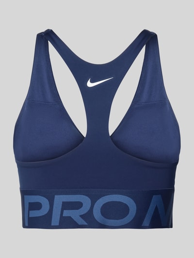 Produktfoto, Bustier mit Label-Details und Cut-Out von NIKE TRAINING in Dunkelblau mit Racerback, körpernahe Passform, sichtbares Logo