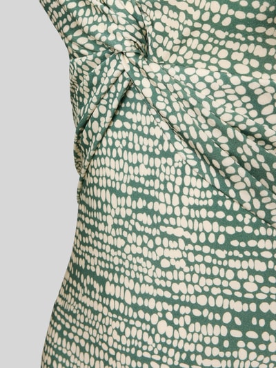 Frauenmodel trägt Badeanzug mit Neckholder Modell 'Cascis' von Barts aus Material-Mix mit Stretch-Anteil, Knoten-Detail, Nahaufnahme Oberkörper.
