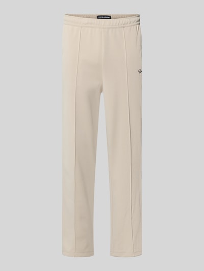 Produktfoto, Sweatpants mit Label-Stitching Modell 'Motus Track Pants' von Pegador, beżowy materiał, krój regular fit, elastyczny pas, kieszeń z tyłu, mieszanka materiałów z bawełną, długość nogawki wewnętrznej 73 cm w rozmiarze M.