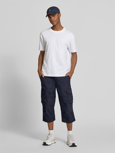Männermodel trägt Capri-Bermudas mit Cargotaschen von camel active in Dunkelblau, Regular Fit, reine Baumwolle, Ganzkörperansicht von vorne.