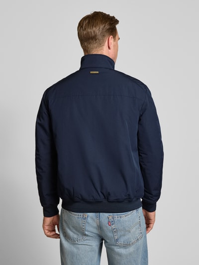 Männermodel trägt Regular Fit Jacke mit Stehkragen von Christian Berg Men in Dunkelblau, elastische Abschlüsse, Ganzkörperansicht Rückansicht. Rückenlänge 69 cm, Schulterbreite 49 cm, Brustweite 55 cm, Ärmellänge 67 cm.
