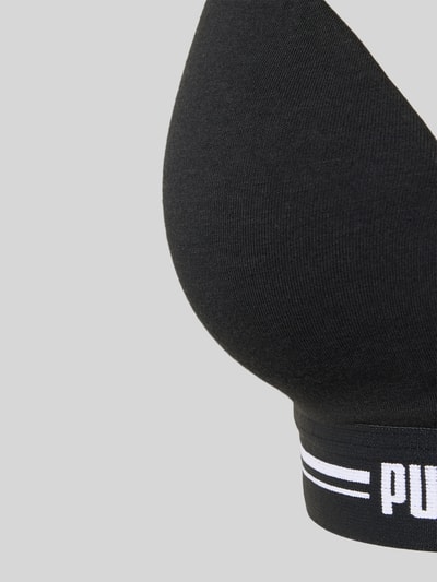 Frauenmodel trägt Bralette mit Logo-Bund von PUMA aus Baumwollmischung mit Modal- und Stretch-Anteil, Nahaufnahme Oberkörper.