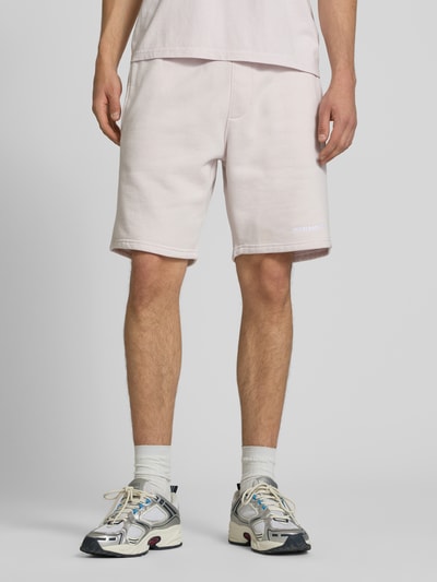 Männermodel trägt Regular Fit Shorts mit Logo-Stitching von Pegador aus Baumwoll-Mix, helle Farbe, elastischer Bund, Ganzkörperansicht von vorne.