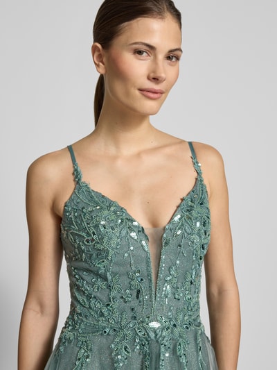 Modelka nosi Regular Fit Abendkleid mit floralem Ziersteinbesatz od Luxuar, zielony mesh, florystyczne zdobienia, błyszcząca faktura, szerokość w rozmiarze 36: 35 cm, długość tyłu 144 cm, zbliżenie na górną część ciała.