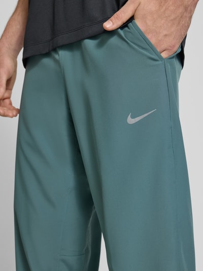 Nike Training Form Pants mit Logo-Print und Eingriffatschen Petrol 3