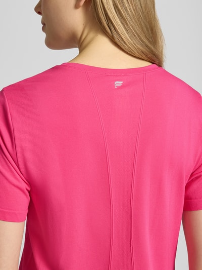 Frauenmodel trägt Regular Fit T-Shirt mit Rundhalsausschnitt Modell 'Feather' von Fabletics in Pink, Elastischer-Material-Mix, Rückenlänge bei Größe S 54 cm, Ganzkörperansicht Rückansicht.