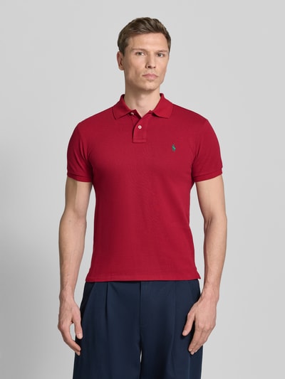 Männermodel trägt Slim Fit Poloshirt aus reiner Baumwolle van Polo Ralph Lauren, look: effen, gestikt logo, piqué, korte mouw, 2-knoopsluiting, met split; Ganzkörperansicht van voren.