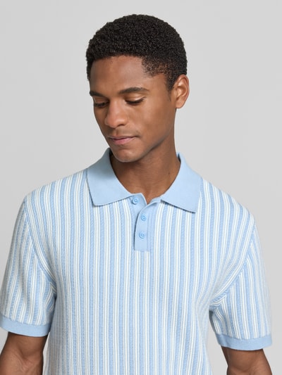 Männermodel trägt Regular Fit Poloshirt in Strick-Optik von MCNEAL aus Reine Baumwolle, hellblau-weiß gestreift, Nahaufnahme Oberkörper.