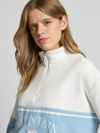Vrouwenmodel draagt Sweatshirt met rits model 'Cosette' van LeGer by Lena Gercke in wit en lichtblauw, katoenmix, relaxed fit, Nahaufnahme bovenlichaam.