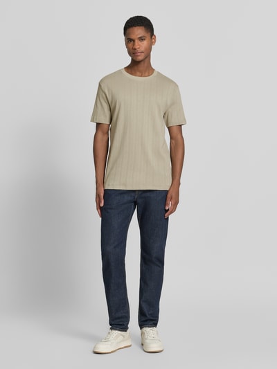 Männermodel trägt T-Shirt in Jaquard-Strick mit Rundhalsausschnitt von Lindbergh, Reine Baumwolle, Regular-Fit, Label-Detail, Beige, Ganzkörperansicht von vorne.
