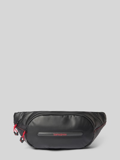 Produktfoto, Bauchtasche mit Logo-Detail Modell 'Ecodiver' von Samsonite in Schwarz mit roten Akzenten, glatte Textur, Reißverschluss, verstellbarer Trageriemen, Hauptfach und Logo auf der Front, Maße: 40x17x6 cm, Schulterriemenlänge 94 cm.