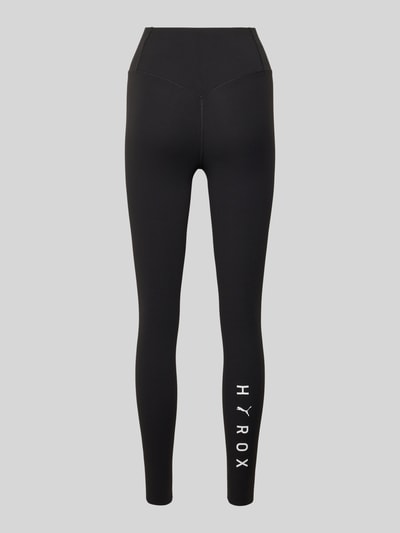 Produktfoto, schwarze Leggings mit elastischem Bund Modell 'PUMA x HYROX SHAPELUXE' von PUMA, körpernahe Passform, Material-Mix mit Stretch-Anteil, sichtbares Logo am Bein.