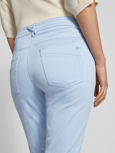 Frauenmodel trägt Tapered Fit Chino aus Baumwoll-Mix von Tom Tailor, Optik: Unifarben, 5-Pocket-Design, Label-Prägung, Nahaufnahme Rückansicht.