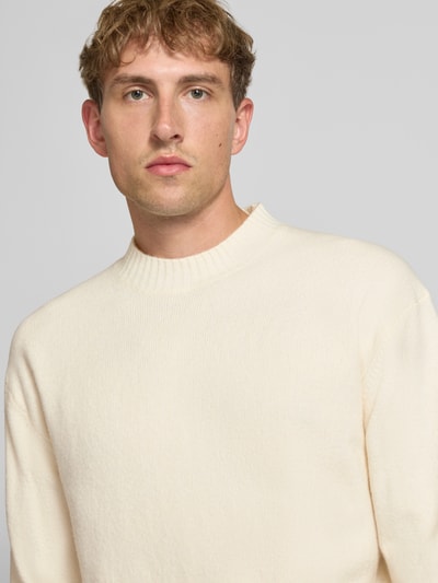 Männermodel trägt Relaxed Fit Strickpullover aus Material-Mix mit Baumwoll-Anteil von REVIEW, helle Farbe, Nahaufnahme Oberkörper.