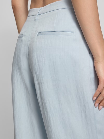 Frauenmodel trägt Wide Leg Hose aus Viskose-Mix von Bardot in Hellblau, feine Textur, Gesäßtaschen, Nahaufnahme Rückansicht. Modell 'GEORDY', Bundweite 39 cm, Innenbeinlänge 84 cm.