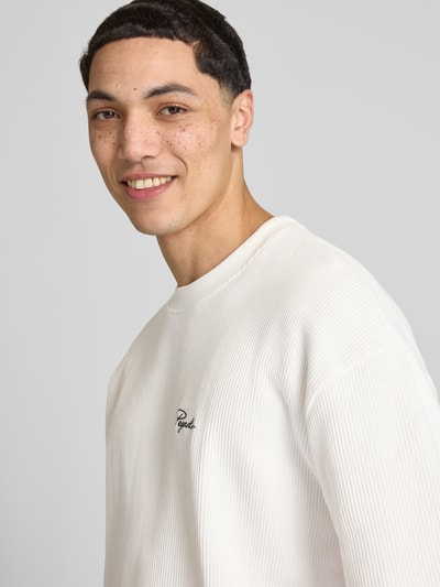 Männermodel trägt Oversized T-Shirt mit Strukturmuster von Pegador aus Baumwoll-Mix, Logo-Stitching, Rundhalsausschnitt, Nahaufnahme Oberkörper.