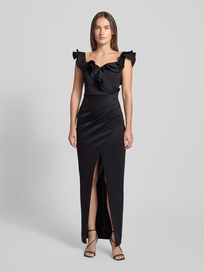 Frauenmodel trägt Abendkleid mit Volants von Lipsy in Schwarz, taillierter Schnitt, Square-Neck, Gehschlitz, Material-Mix, Ganzkörperansicht von vorne.