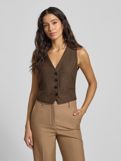 Frauenmodel trägt Regular Fit Weste mit V-Ausschnitt Modell 'PIPER' von Mango in Braun, Knopfleiste, Paspeltaschen, Nahaufnahme Oberkörper.