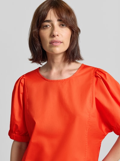 Frauenmodel trägt Regular Fit Bluse mit Puffärmeln Modell 'SOLID' von Fynch-Hatton in leuchtend Orange, Rundhalsausschnitt, Nahaufnahme Oberkörper.