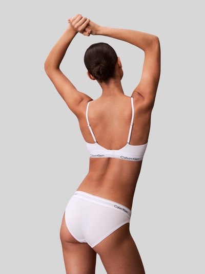 Frauenmodel trägt Balconette BH mit Logo-Stitching von Calvin Klein Underwear in Weiß aus elastischem Baumwoll-Mix mit Modal-Anteil, Verstellbare Träger, Haken-Verschluss, Ganzkörperansicht Rückansicht.