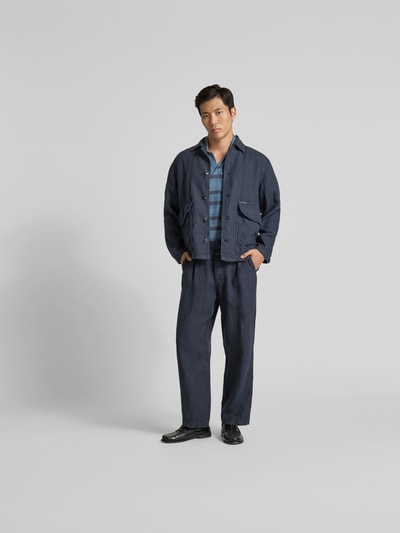 Männermodel trägt Hemdjacke aus reinem Leinen von Closed in Dunkelblau, Regular Fit mit Pattentaschen, Ganzkörperansicht von vorne.