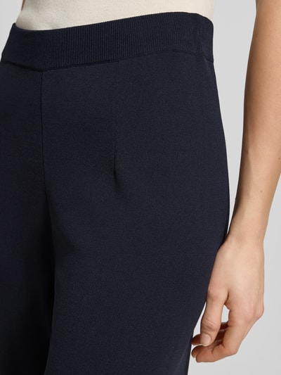 Frauenmodel trägt Jogpants aus Viskose-Mix mit elastischem Bund von Christian Berg Woman Selection, dunkelblau, Straight Fit, Nahaufnahme Oberkörper.
