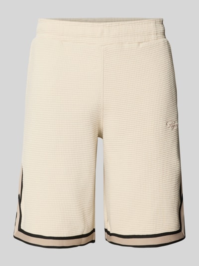 Produktfoto, Shorts mit Strukturmuster und Label-Stitching von PEGADOR aus reiner Baumwolle in Beige mit Regular-Fit, elastischem Bund und Eingrifftaschen.