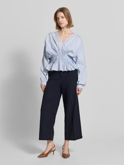 Frauenmodel trägt Stoffhose mit Eingrifftaschen Modell 'CARA' von Cambio, Wide-Fit, Bügelfalte, Haken-Reißverschluss, Ganzkörperansicht von vorne.