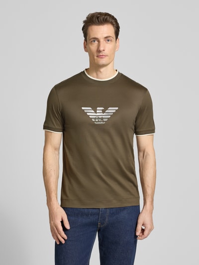 Männermodel trägt Regular Fit T-Shirt mit Logo-Stitching von Emporio Armani, olivgrün, Lyocell-Mix, Rundhalsausschnitt, Ganzkörperansicht von vorne.