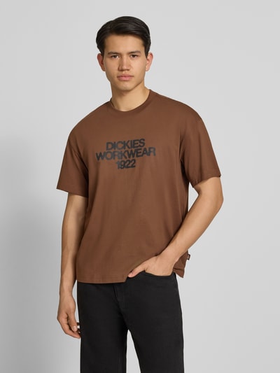 Mannelijk model draagt T-shirt met Label-Print model 'TORREY' van Dickies, puur katoen, regular fit, ronde hals, ruglengte maat M 70 cm, Ganzkörperansicht von voren.
