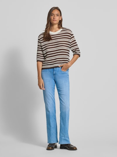 Frauenmodel trägt Flared Fit Jeans aus Baumwoll-Mix Modell 'PARIS' von Cambio in hellblauem Denim, 5-Pocket-Design, Ganzkörperansicht von vorne.