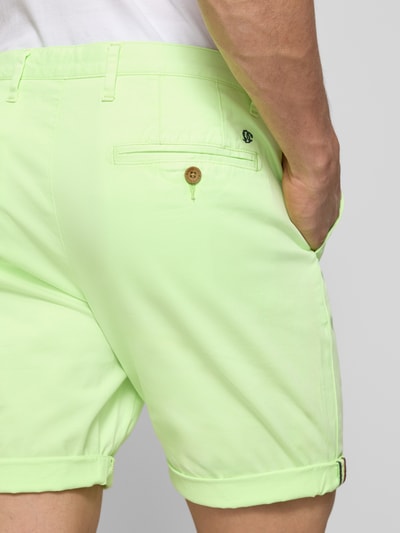 Männermodel trägt Regular Fit Shorts mit Münztasche von Superdry in Hellgrün aus Baumwoll-Mix, Gesäßtaschen, Knopf-Reißverschluss, Detailaufnahme Rückansicht.