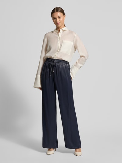 Frauenmodel trägt Wide Leg Hose aus reiner Viskose Modell 'TAVATI' von BOSS in Optik: Unifarben, Satin Materialverarbeitung, Ganzkörperansicht von vorne.