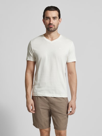 Männermodel trägt Regular Fit T-Shirt aus reiner Baumwolle von Tom Tailor, unifarben, mit V-Ausschnitt und Logo-Stitching, Ganzkörperansicht von vorne.