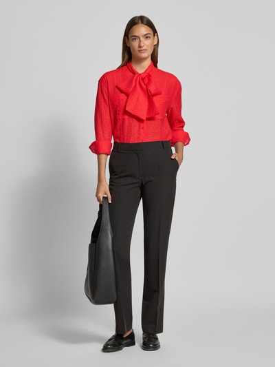 Frauenmodel trägt Regular Fit Schluppenbluse aus Viskose-Mix von Christian Berg Woman in Rot mit Knopfleiste und Brusttasche, Ganzkörperansicht von vorne. Rückenlänge 67 cm, Ärmellänge 55 cm, geeignet für Damen.