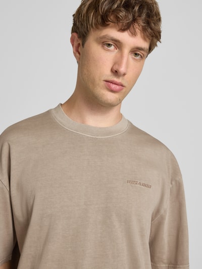 Männermodel trägt Oversized T-Shirt mit Label-Stitching von Pegador aus Baumwoll-Mix, Rundhalsausschnitt, Nahaufnahme Oberkörper.