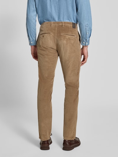Männermodel trägt Modern Fit Cordhose aus Baumwoll-Mix Modell 'Fabio' von Brax, schmale Passform, beige, samtige Textur, Ganzkörperansicht Rückansicht, Herren Schmale Hose von Brax.