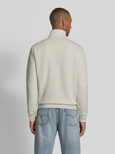 Männermodel trägt Relaxed Fit Troyer aus Baumwoll-Mix von Polo Ralph Lauren in Creme mit glatter Textur, Ganzkörperansicht Rückansicht.