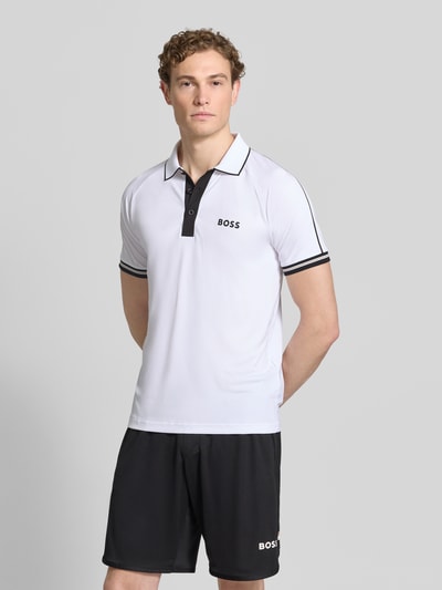 Männermodel trägt Regular Fit Poloshirts mit Kontrastdetails von BOSS Green, Two-Tone-Optik, Polokragen, 2-Knopf-Verschluss, Ganzkörperansicht von vorne.