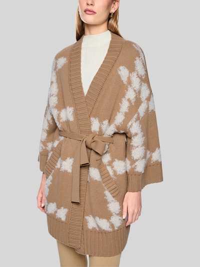 Vrouwenmodel draagt Cardigan met Bindegürtel en 3/4-mouw van Marc Cain, Materiaalmix met alpaca, regular fit, all-over look, strikceintuur, ruglengte maat 36: 86 cm, mouwlengte maat 36: 27 cm, all-over patroon in beige en wit, structuur grof gebreid, Nahaufnahme bovenlichaam.