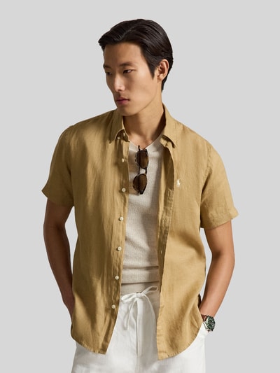 Mannenmodel draagt Regular Fit Leinenhemd met Button-Down-Kragen van Polo Ralph Lauren, look: effen kleuren, regular fit pasvorm, button-downkraag, doorlopende knoopsluiting, gestikt logo, korte mouw, rompzoom licht afgerond, materiaal: puur linnen. Vooraanzicht bovenlichaam.
