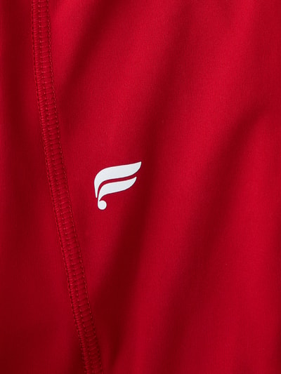 Produktfoto, Slim Fit Leggins mit Beintaschen Modell 'OASIS' von Fabletics in leuchtendem Rot, Elastischer-Material-Mix, glatte Textur, breiter Bund.