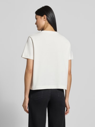 Männermodel trägt Boxy Fit T-Shirt aus reiner Baumwolle Modell 'SARA' von VERO MODA, Damen T-Shirt, kolor biały, proste linie, gładka faktura, Ganzkörperansicht Rückansicht.