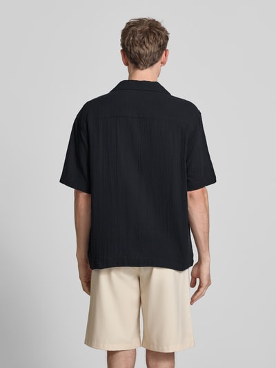 Männermodel trägt Relaxed Fit Freizeithemd aus reiner Baumwolle Modell 'JACKSON' von Only & Sons, Optik: Unifarben, Passform: Relaxed-Fit, Hemdkragen, durchgehend Knopfleiste, Stickerei, Verschluss: einreihige Knopfleiste, Ärmelform: Kurzarm, Materialverarbeitung: Seersucker, Material: Reine Baumwolle, Ganzkörperansicht Rückansicht.