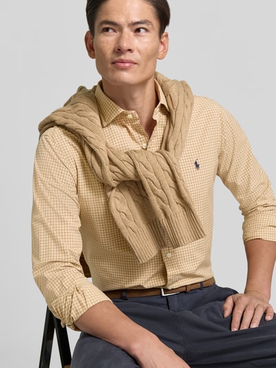 Männermodel trägt Custom Fit Freizeithemd aus reiner Baumwolle von Polo Ralph Lauren in Beige kariert, Nahaufnahme Oberkörper.